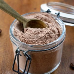 Jar of Mocha Latte Mix with a wooden measuring spoon in the jar.