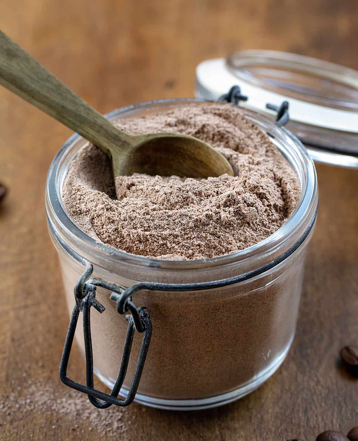Jar of Mocha Latte Mix with a wooden measuring spoon in the jar.