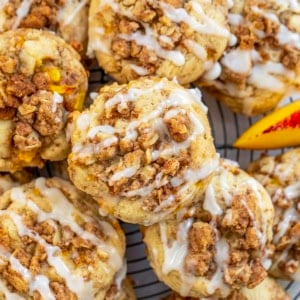 Peach Crisp Cookies stacked on a cool rack on a white table from overhead.