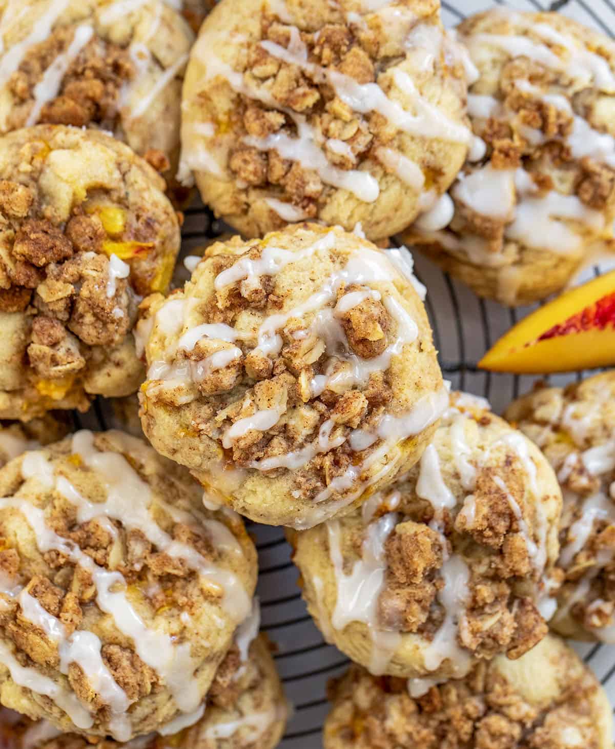 Peach Crisp Cookies stacked on a cool rack on a white table from overhead.