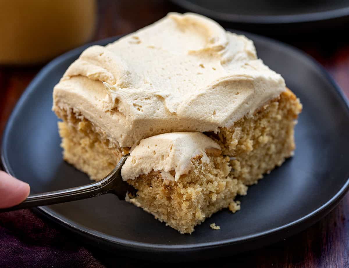 Fork taking a bite out of a piece of Peanut Butter Sheet Cake Fork taking a bite out of a piece of Peanut Butter Sheet Cake.