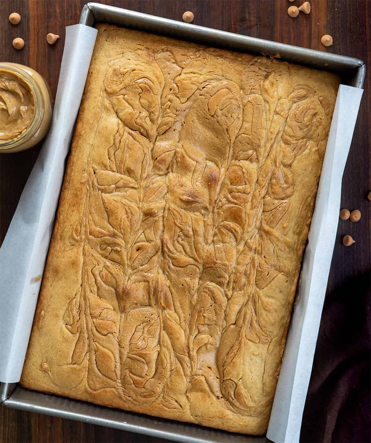 Peanut Butter Sheet Cake on a wooden table from overhead Peanut Butter Sheet Cake on a wooden table from overhead.