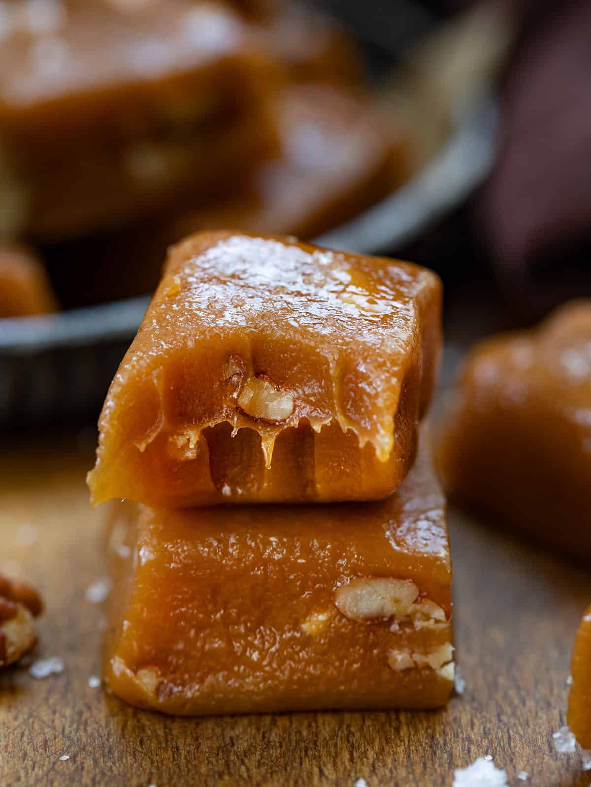 Small stack of Soft Salted Pecan Caramels with the top caramel bit into.