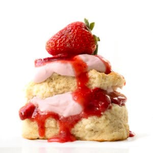 Strawberry Shortcake with Strawberry Stabilized Whipped Cream close up on a white table.