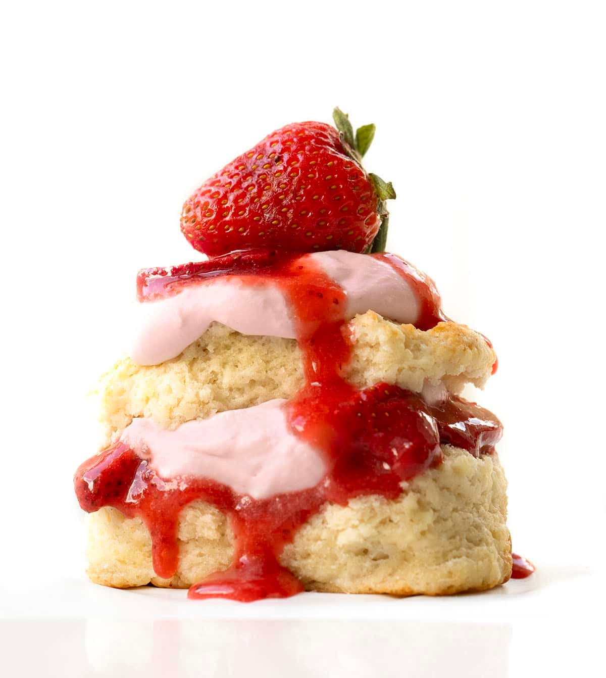 Strawberry Shortcake with Strawberry Stabilized Whipped Cream close up on a white table.