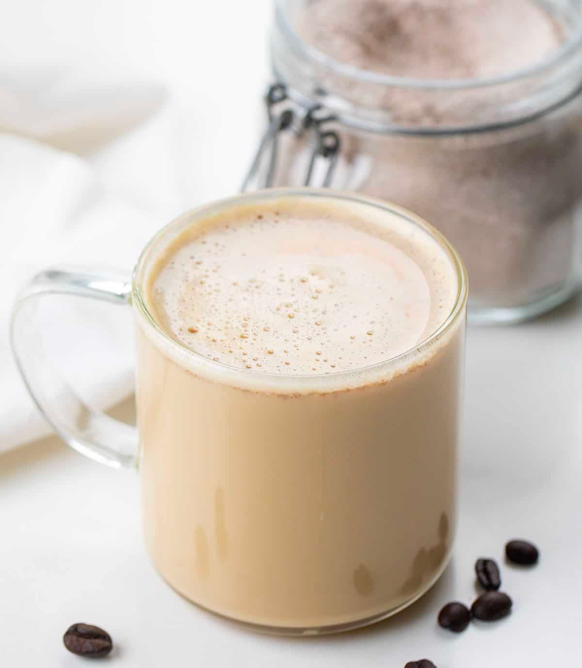 Hot vanilla latte in a glass mug in front of a jar of Vanilla Latte Mix Hot vanilla latte in a glass mug in front of a jar of Vanilla Latte Mix.