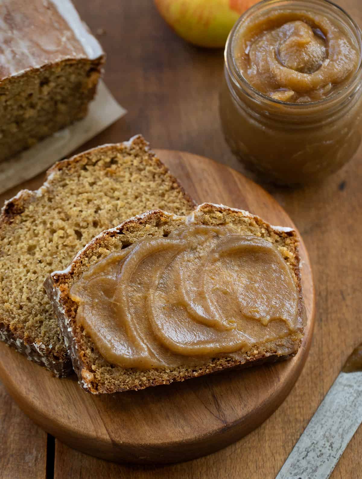 Pieces of Apple Butter Bread covered in apple butter on a wooden table from overhead Pieces of Apple Butter Bread covered in apple butter on a wooden table from overhead.