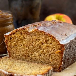 Cut into loaf of Apple Butter Bread with one slice laying flat in front of the loaf.