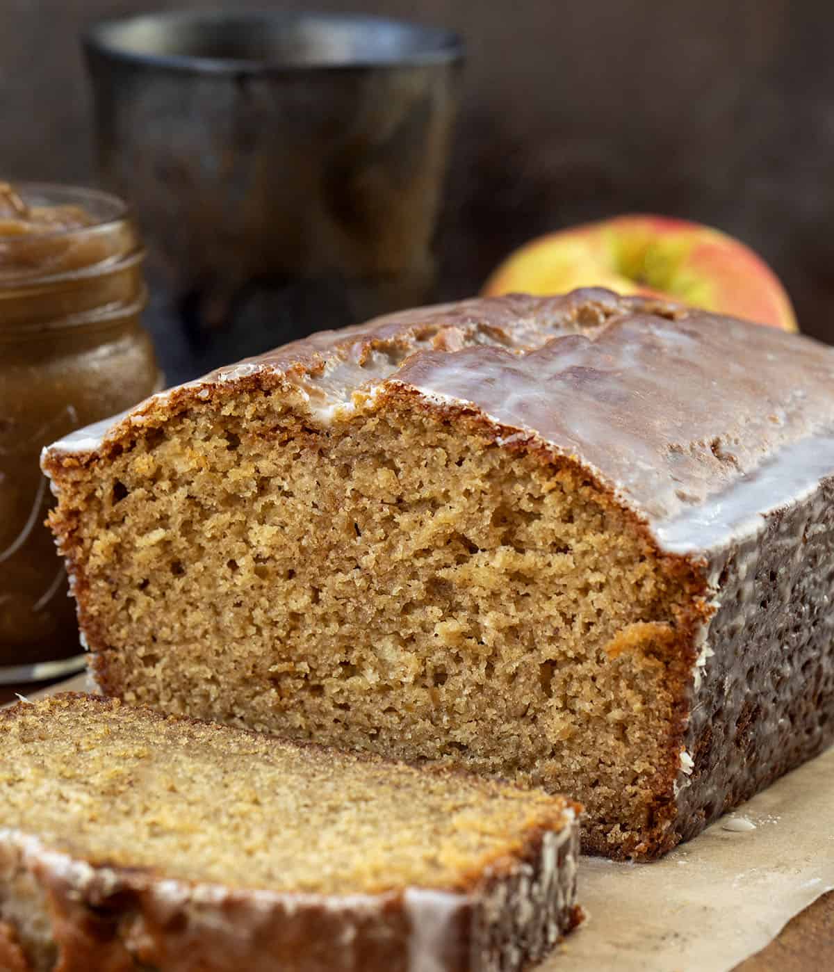Cut into loaf of Apple Butter Bread with one slice laying flat in front of the loaf.