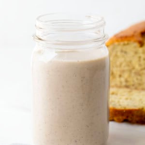 Jar of Banana Bread Coffee Creamer in front of banana bread.