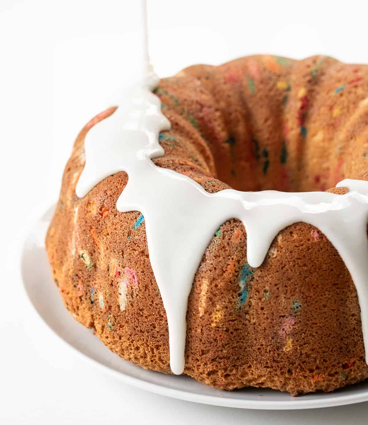 Drizzling vanilla glaze over a birthday pound cake Drizzling vanilla glaze over a birthday pound cake.