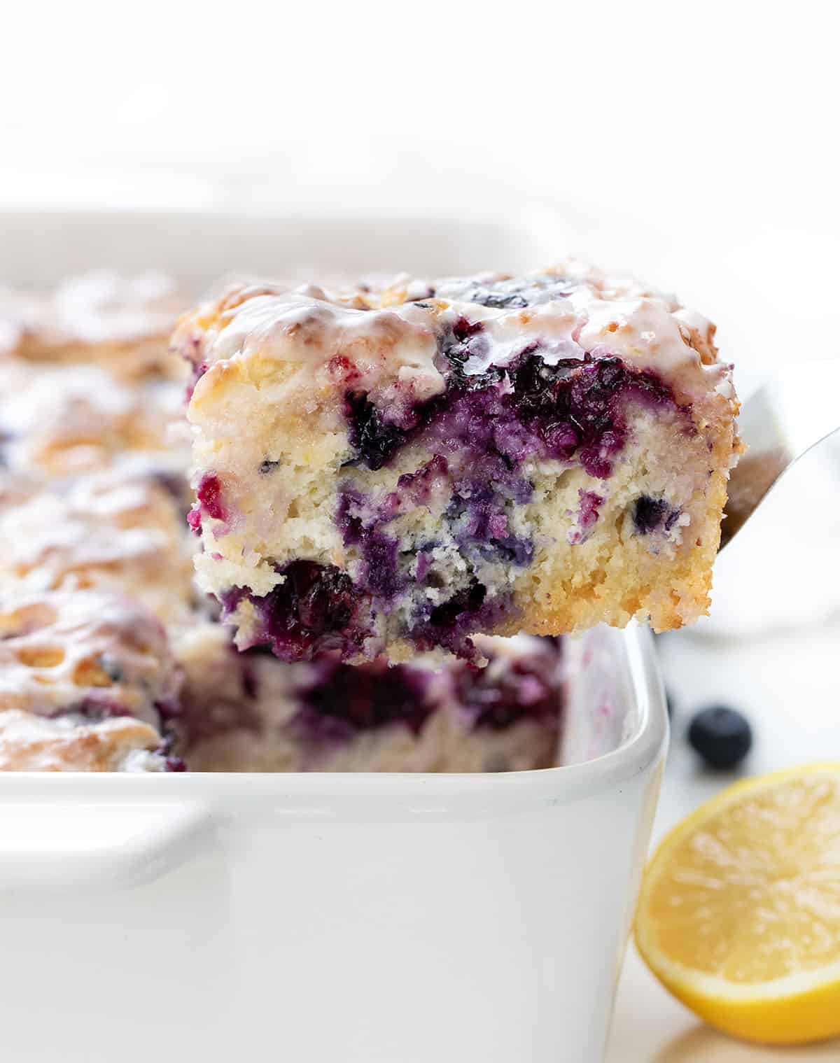 Lifting a Blueberry Lemon Butter Swim Biscuit out of the pan.