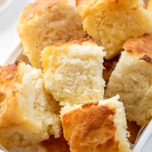 Close up of butter swim biscuits in a white basket.