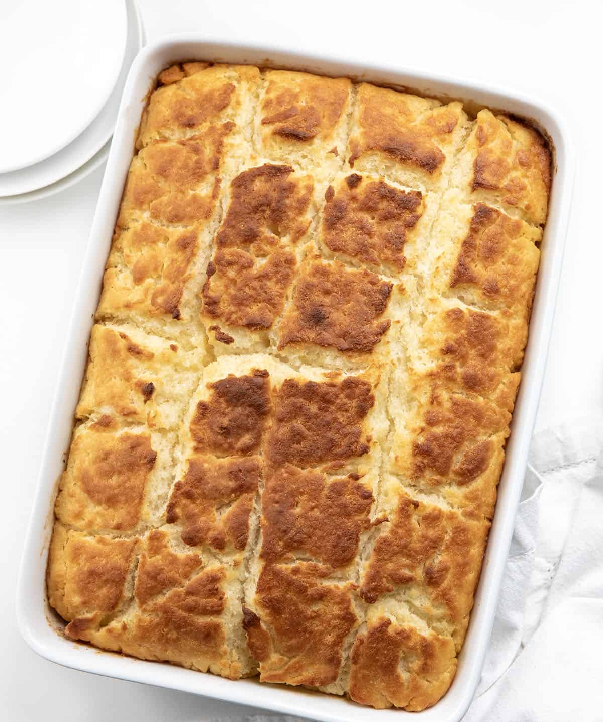 Pan of Butter Swim Biscuits for a Crowd on a white table from overhead.