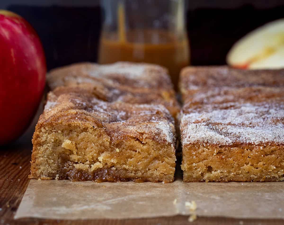 Close up of cut into Caramel Apple Cider Blondies showing the layer of caramel at the bottom of the blondies Close up of cut into Caramel Apple Cider Blondies showing the layer of caramel at the bottom of the blondies.