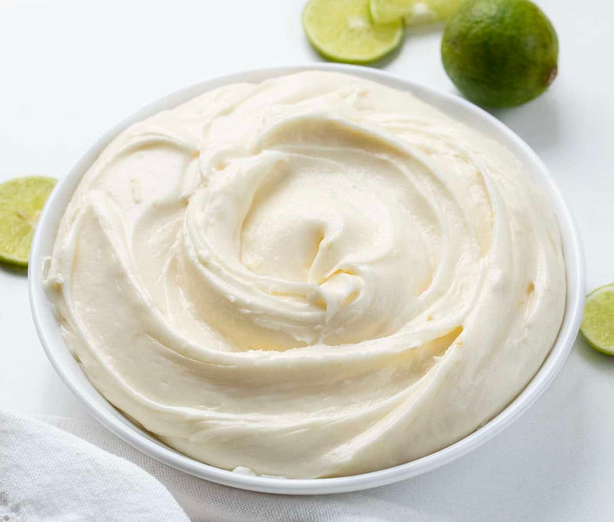 White bowl filled with Key Lime Marshmallow Buttercream.