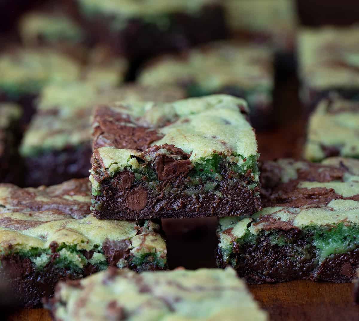 Mint Chocolate Chip Brookies on a wooden table with one stacked.