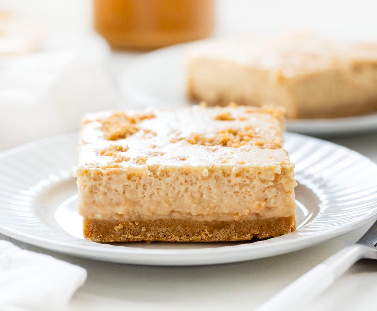 White plates with Peanut Butter Icebox Cheesecake on them on a white table with a white towel.