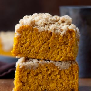 Pumpkin Streusel Sheet Cake pieces stacked on a wooden table.
