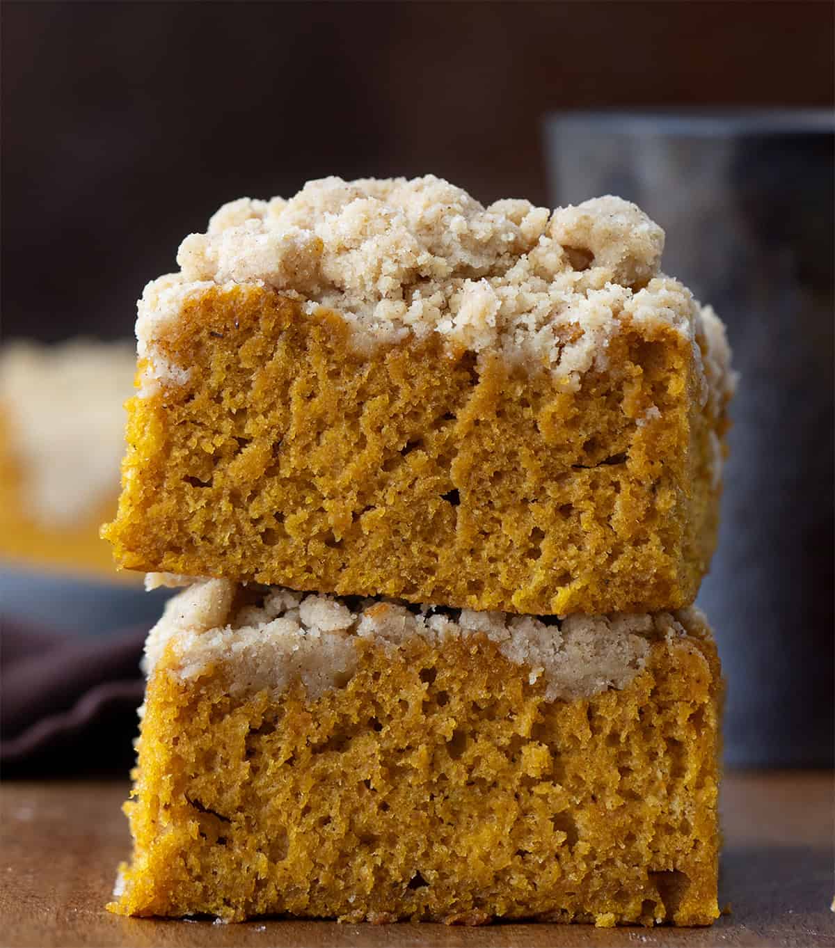 Pumpkin Streusel Sheet Cake pieces stacked on a wooden table.
