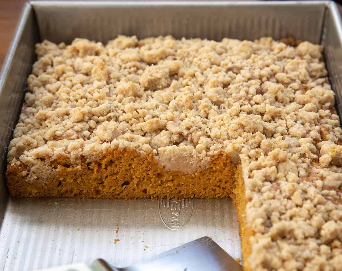 Pumpkin Streusel Sheet Cake in the pan with a few pieces missing.