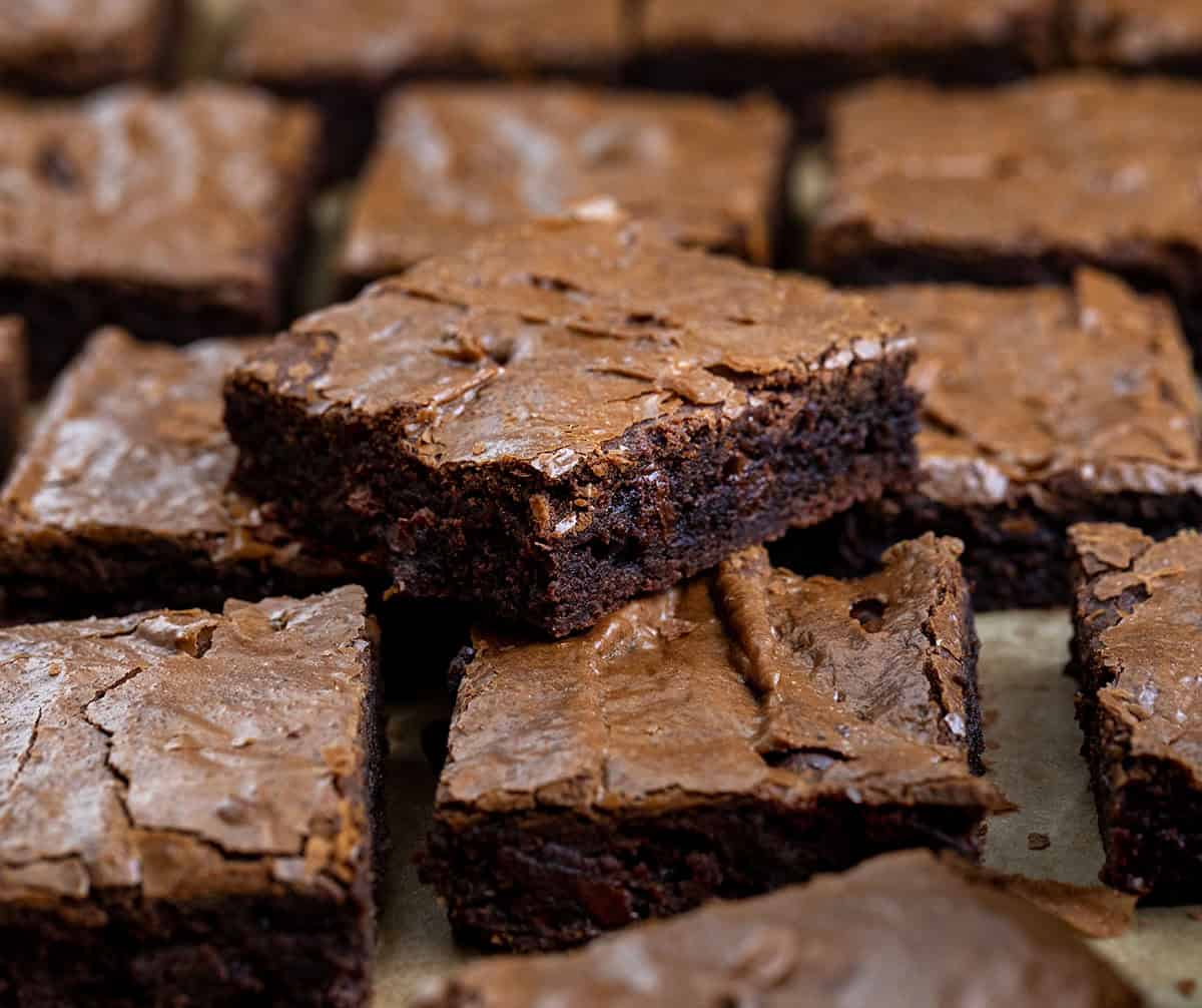 Small stack of Sheet Pan Brownies surrounded by more brownies Small stack of Sheet Pan Brownies surrounded by more brownies.