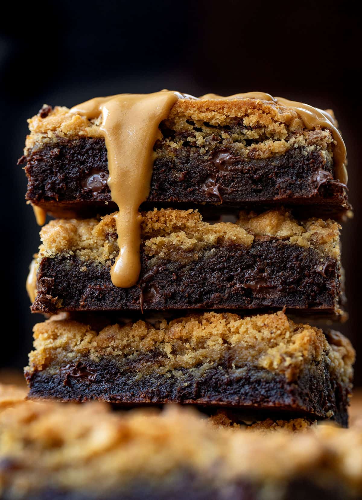 Stack of Peanut Butter Brookies on a wooden table surrounded by more and with a peanut butter drizzle Stack of Peanut Butter Brookies on a wooden table surrounded by more and with a peanut butter drizzle.