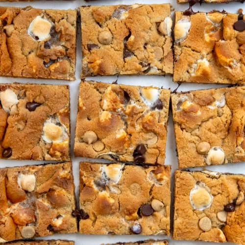 Sheet Pan Peanut Butter Marshmallow Cookies cut into squares on a white table.