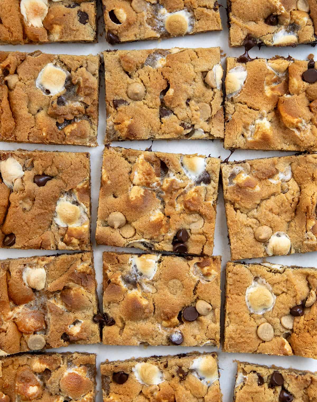 Sheet Pan Peanut Butter Marshmallow Cookies cut into squares on a white table.