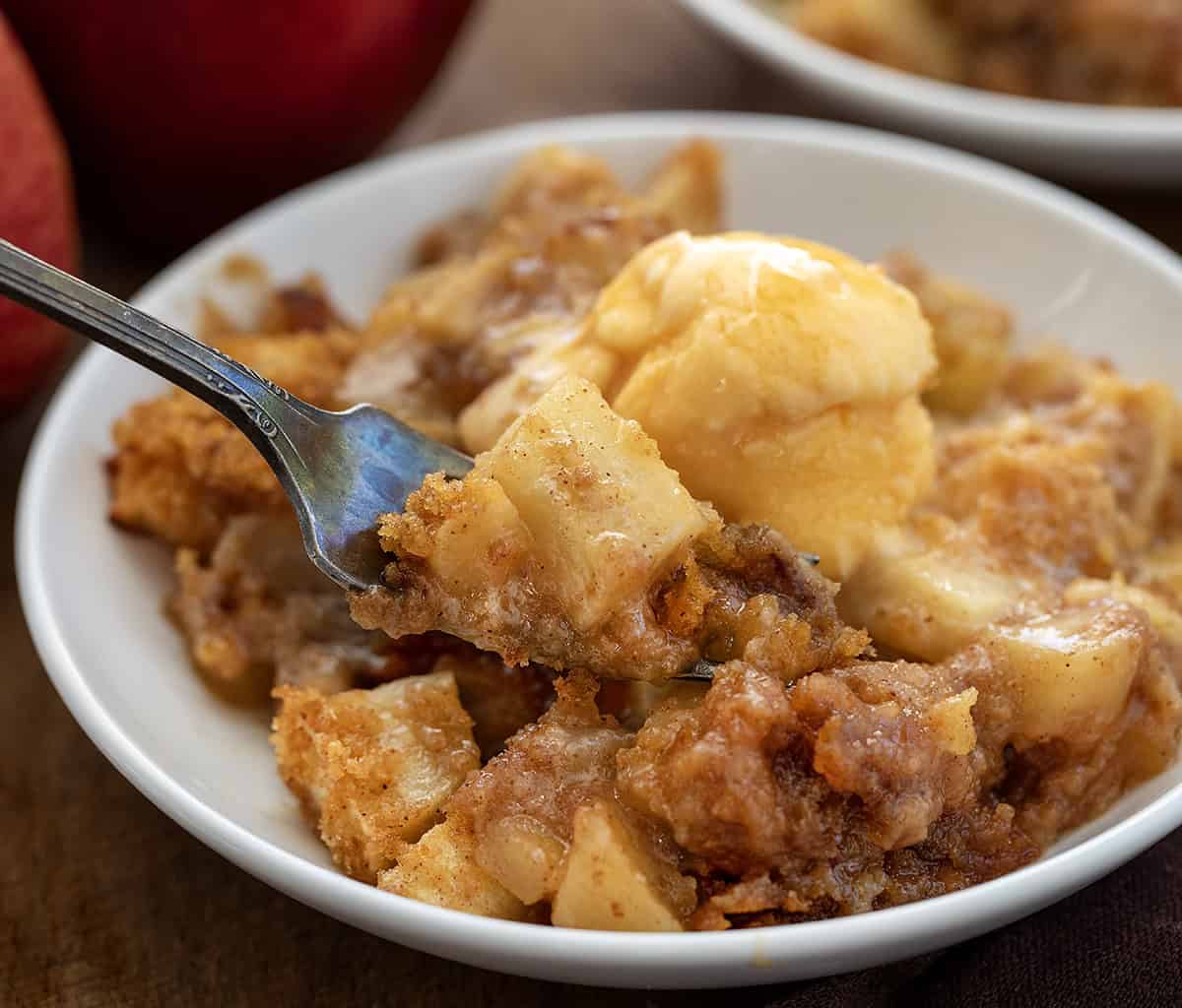 Forkful of Apple Brown Betty being held above the bowl Forkful of Apple Brown Betty being held above the bowl.