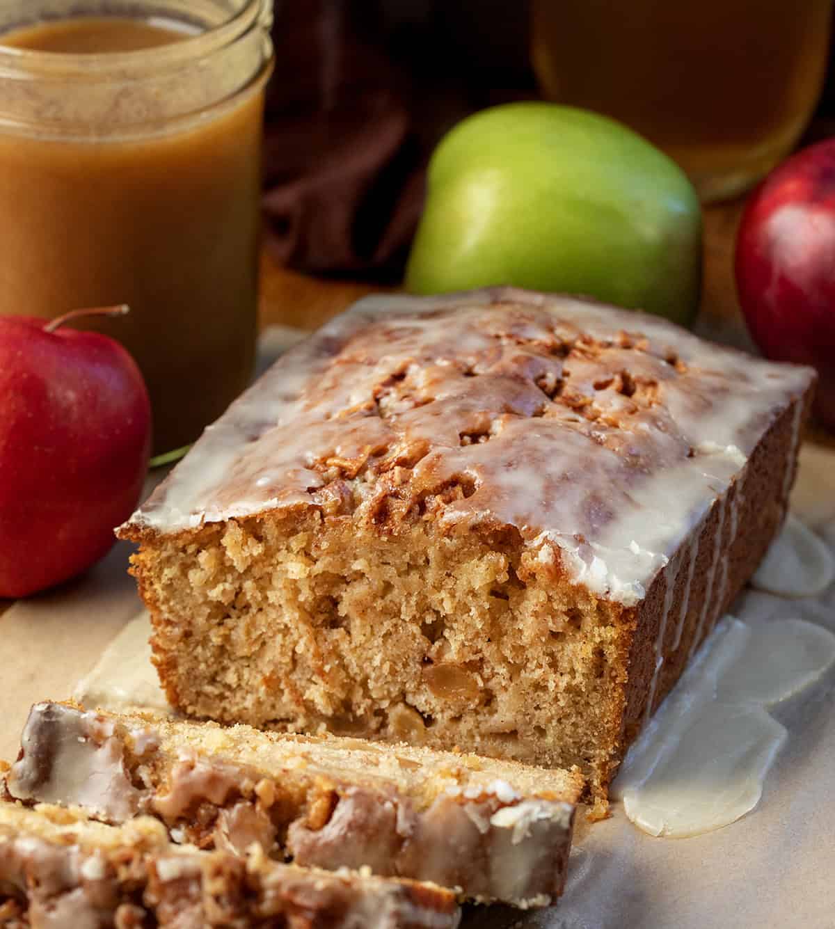 Loaf of Apple Cider Fritter Bread that has been cut into and a few slices are laying in front of.