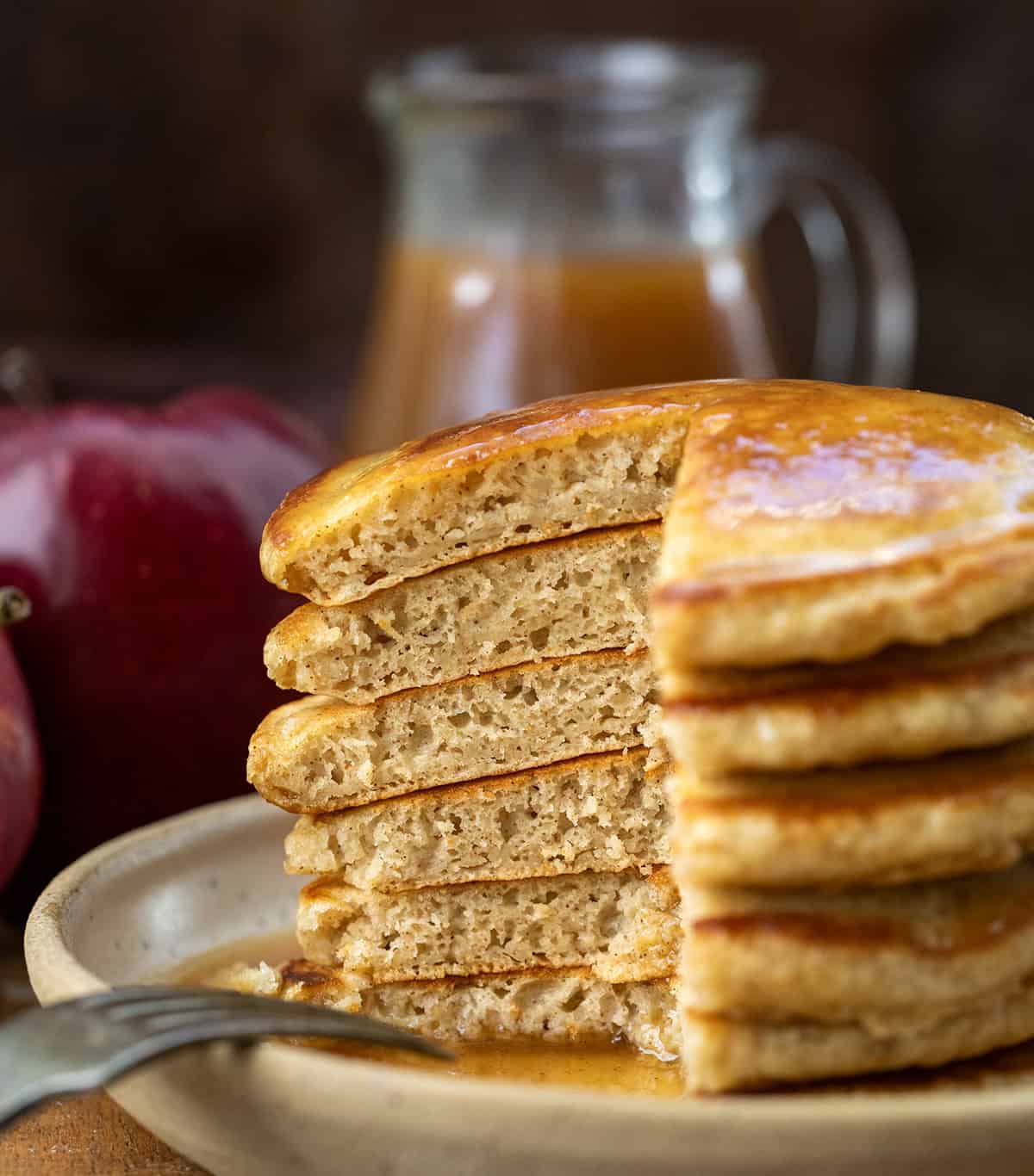 Stack of Apple Cider Pancakes with a portion removed showing the inside and how light and fluffy they are Stack of Apple Cider Pancakes with a portion removed showing the inside and how light and fluffy they are.