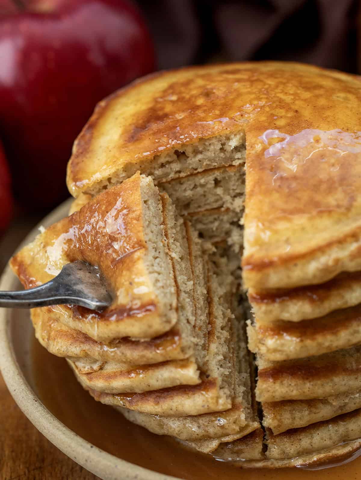 Removing a portion of Apple Cider Pancakes from the stack Removing a portion of Apple Cider Pancakes from the stack.