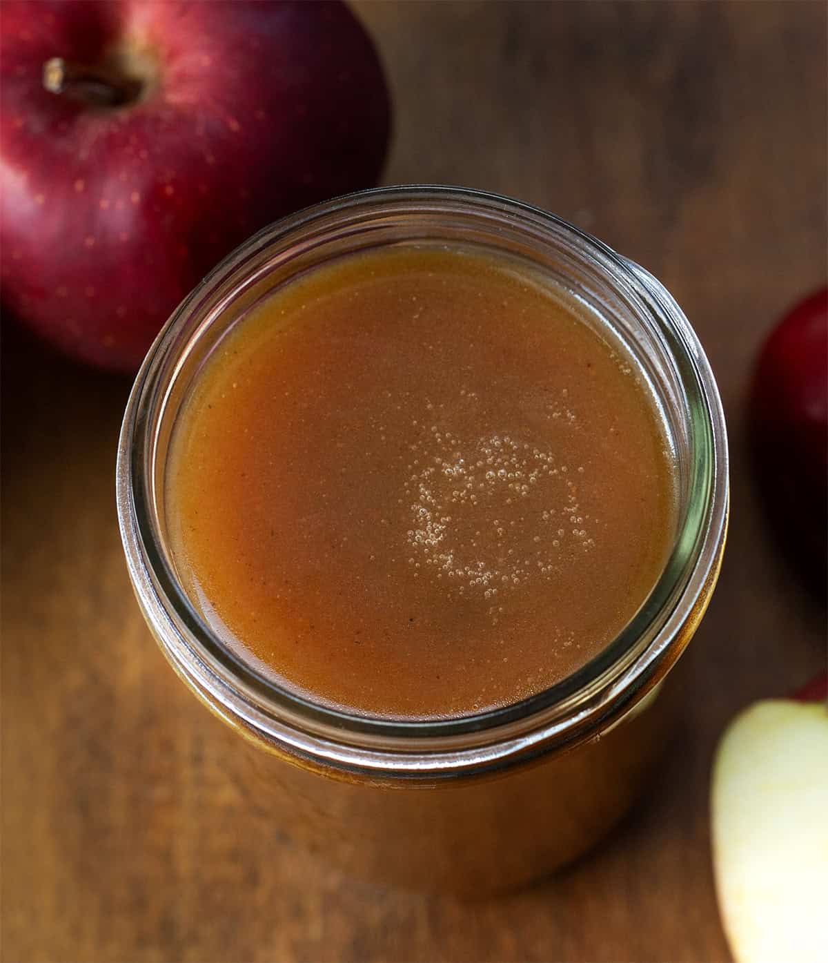 Looking down on a glass mason jar of Apple Cider Syrup.