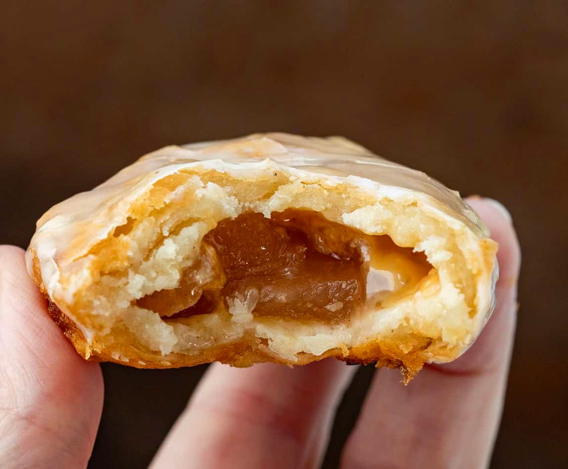 Hand holding a halved Caramel Apple Hand Pie close up.