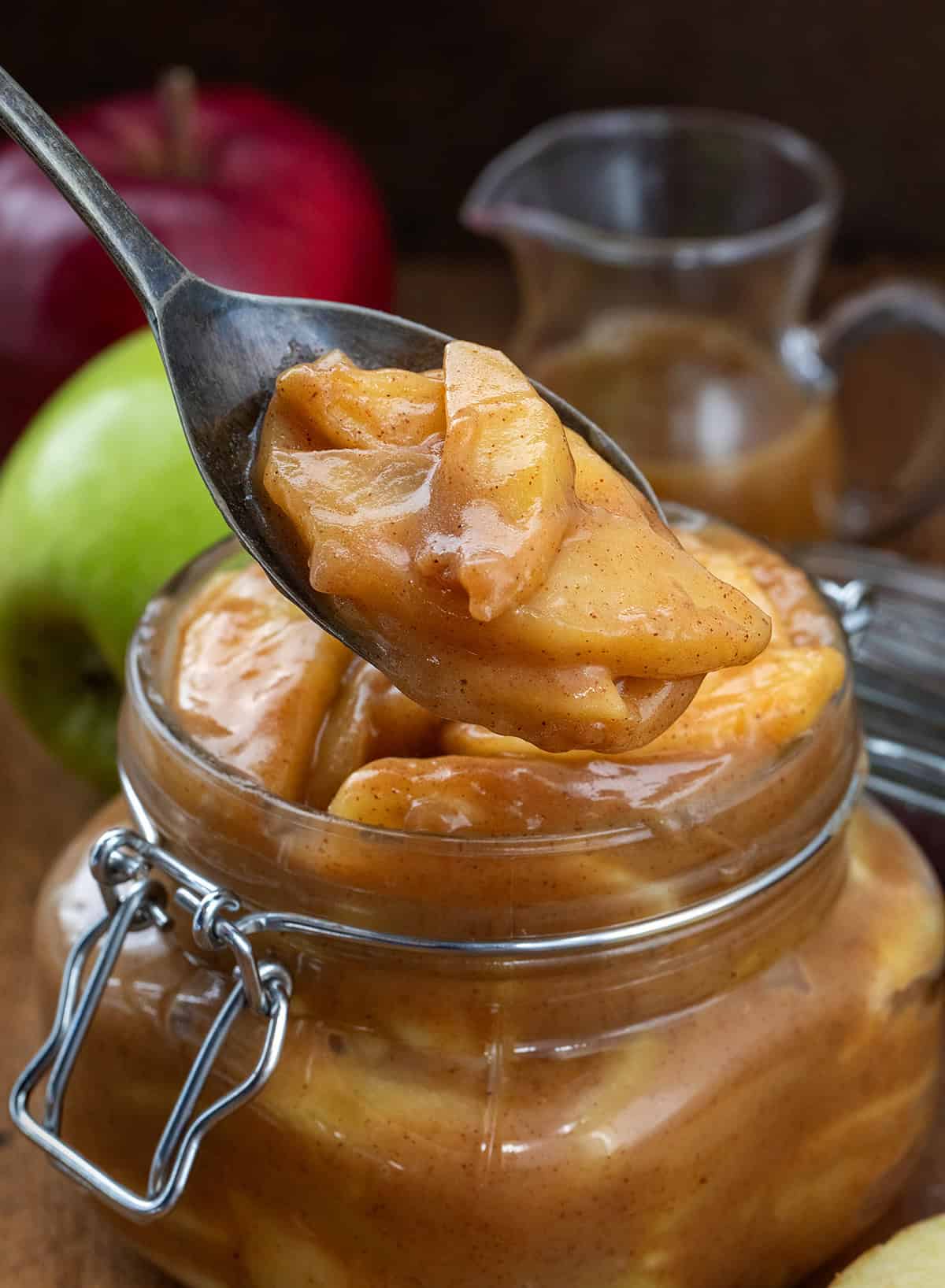 Spoonful of Caramel Apple Pie Filling being held above the jar Spoonful of Caramel Apple Pie Filling being held above the jar.