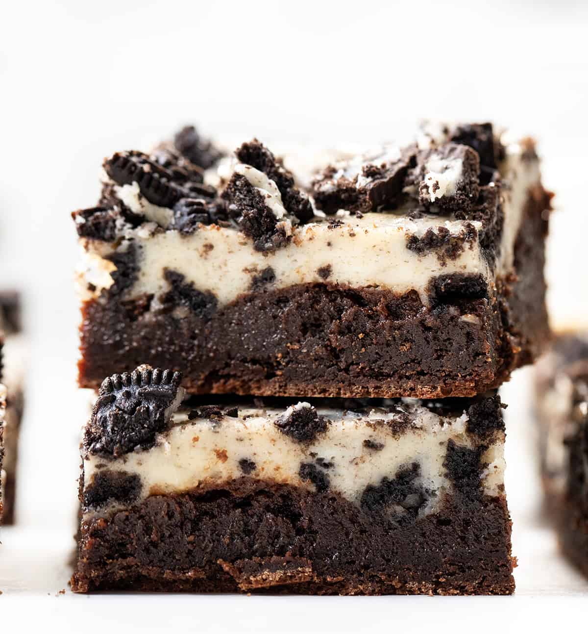 Small stack of Cookies and Cream Brownies very close up on a white table.