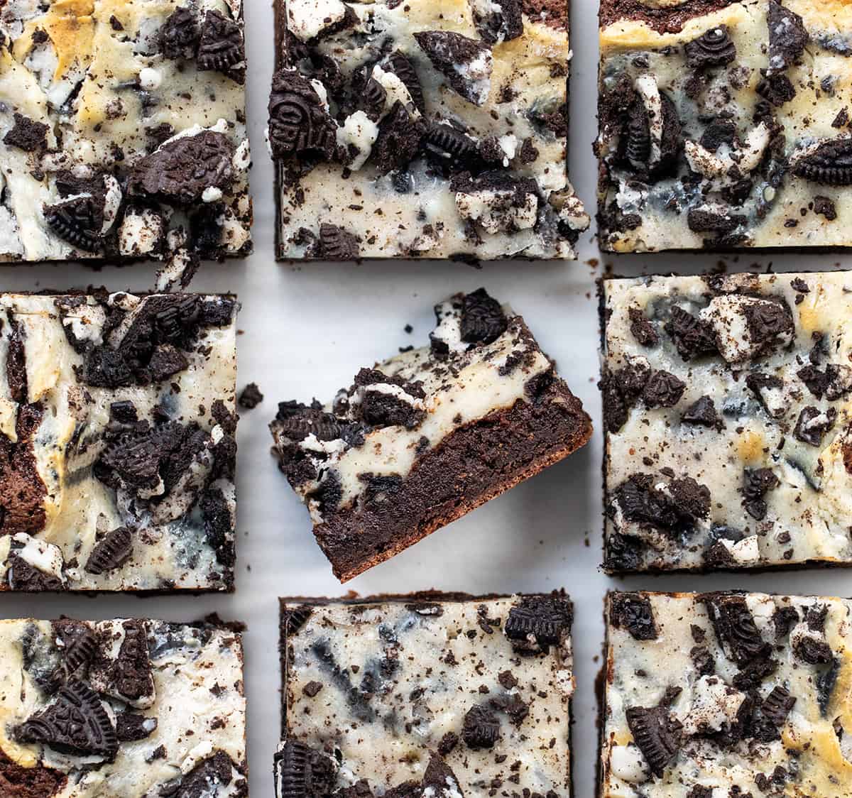 Cookies and Cream Brownies cut into squares with the center brownie on its side.