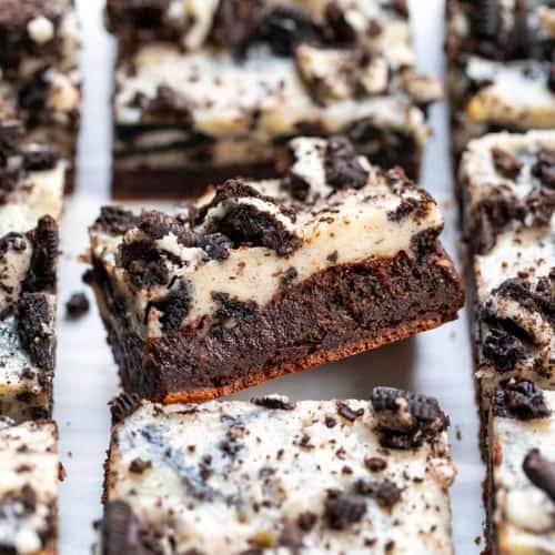 Close up of a Cookies and Cream Brownie at an angle surrounded by more brownies.