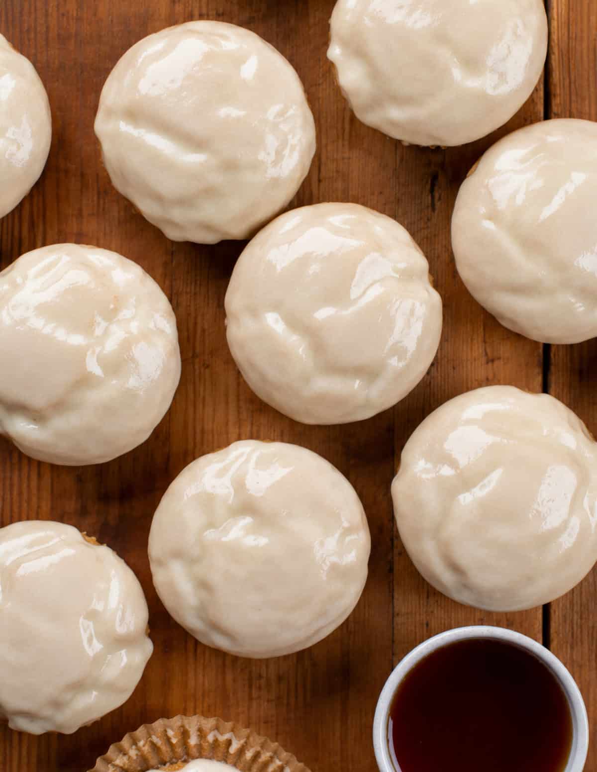 Maple Glazed Donut Muffins on a wooden table from overhead.