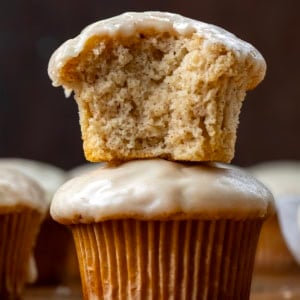 Maple Glazed Donut Muffins stacked with the top muffin halved showing the insider texture.