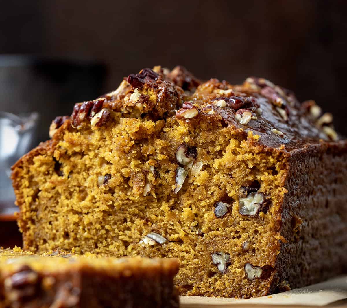 Close up of a cut loaf of Maple Pecan Pumpkin Bread showing the texture inside Close up of a cut loaf of Maple Pecan Pumpkin Bread showing the texture inside.