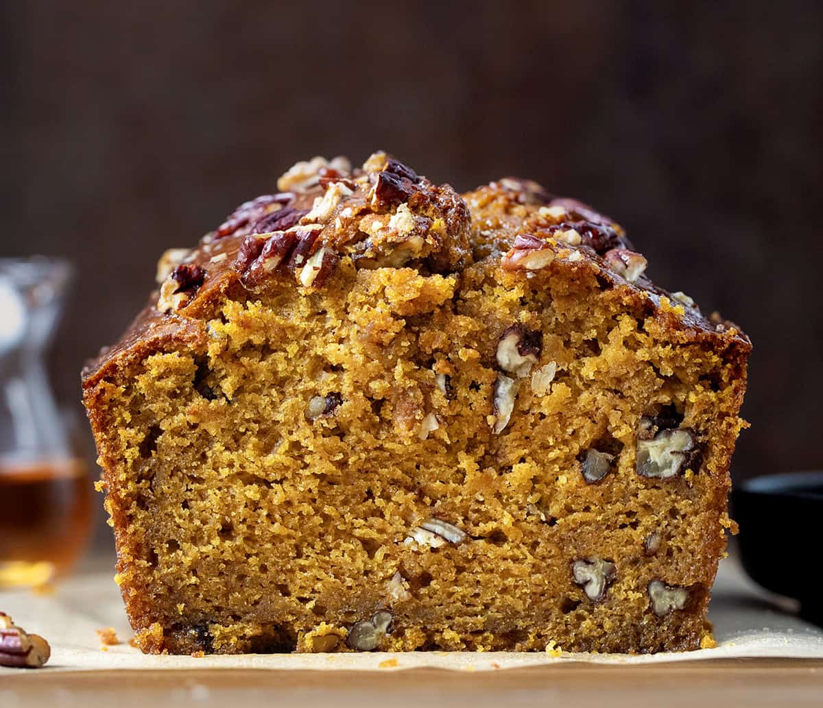 Close up of a cut loaf of Maple Pecan Pumpkin Bread showing the texture inside.