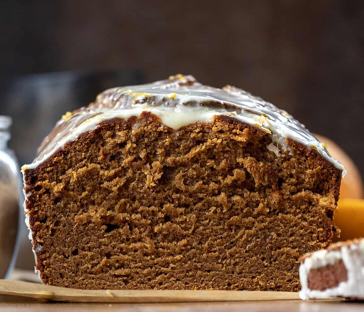 Half a loaf of Orange Gingerbread Loaf with the inside exposed showing a tender crumb.