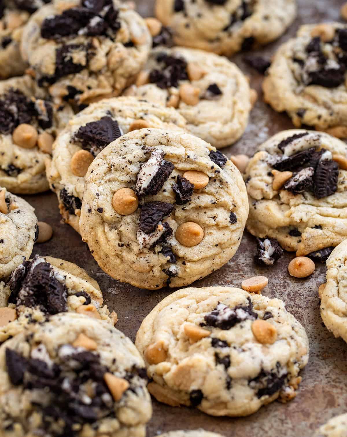 Peanut Butter Oreo Cookies on a table with a few cookies laying on other cookies.