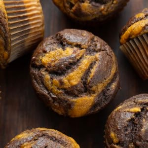 Pumpkin Chocolate Marble Muffins on a wooden table close up.