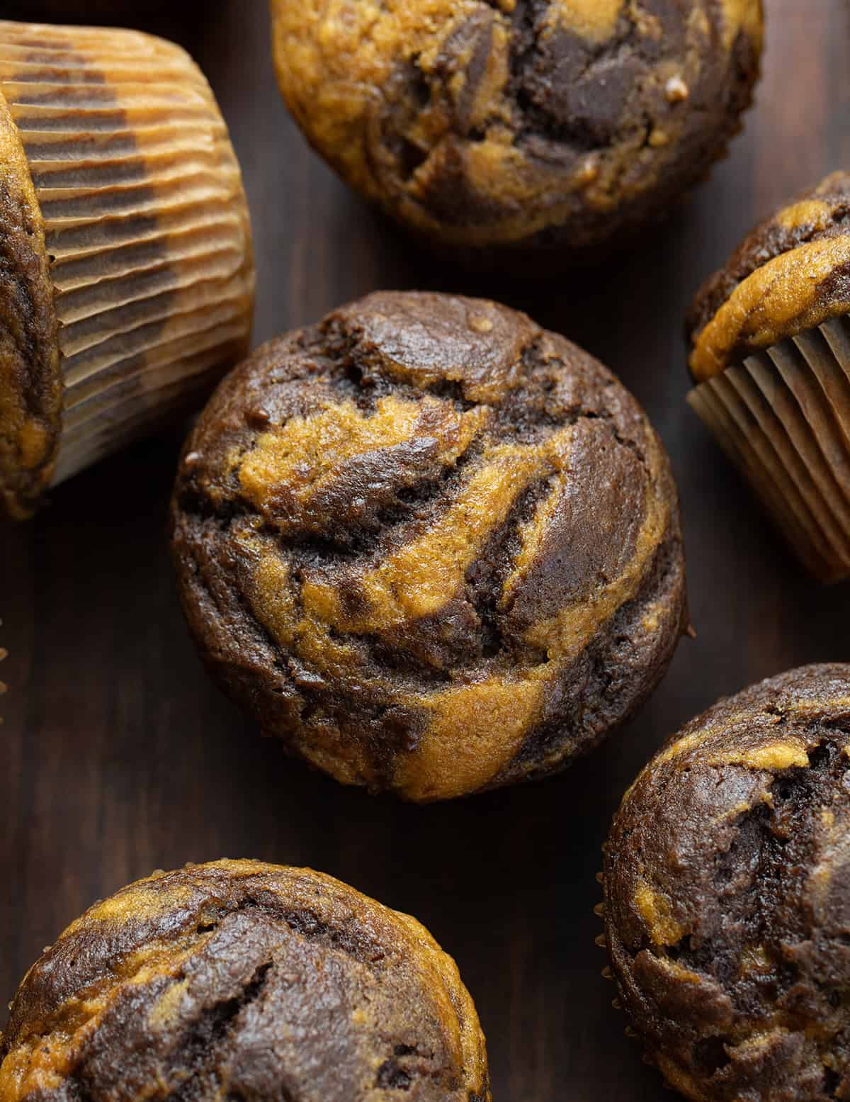 Pumpkin Chocolate Marble Muffins on a wooden table close up.