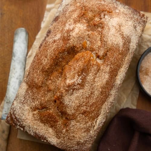 Pumpkin Donut Bread on a wooden table from overhead.