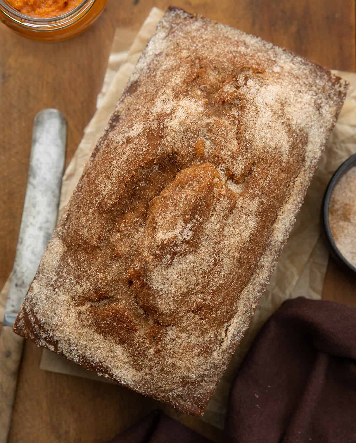 Pumpkin Donut Bread on a wooden table from overhead.