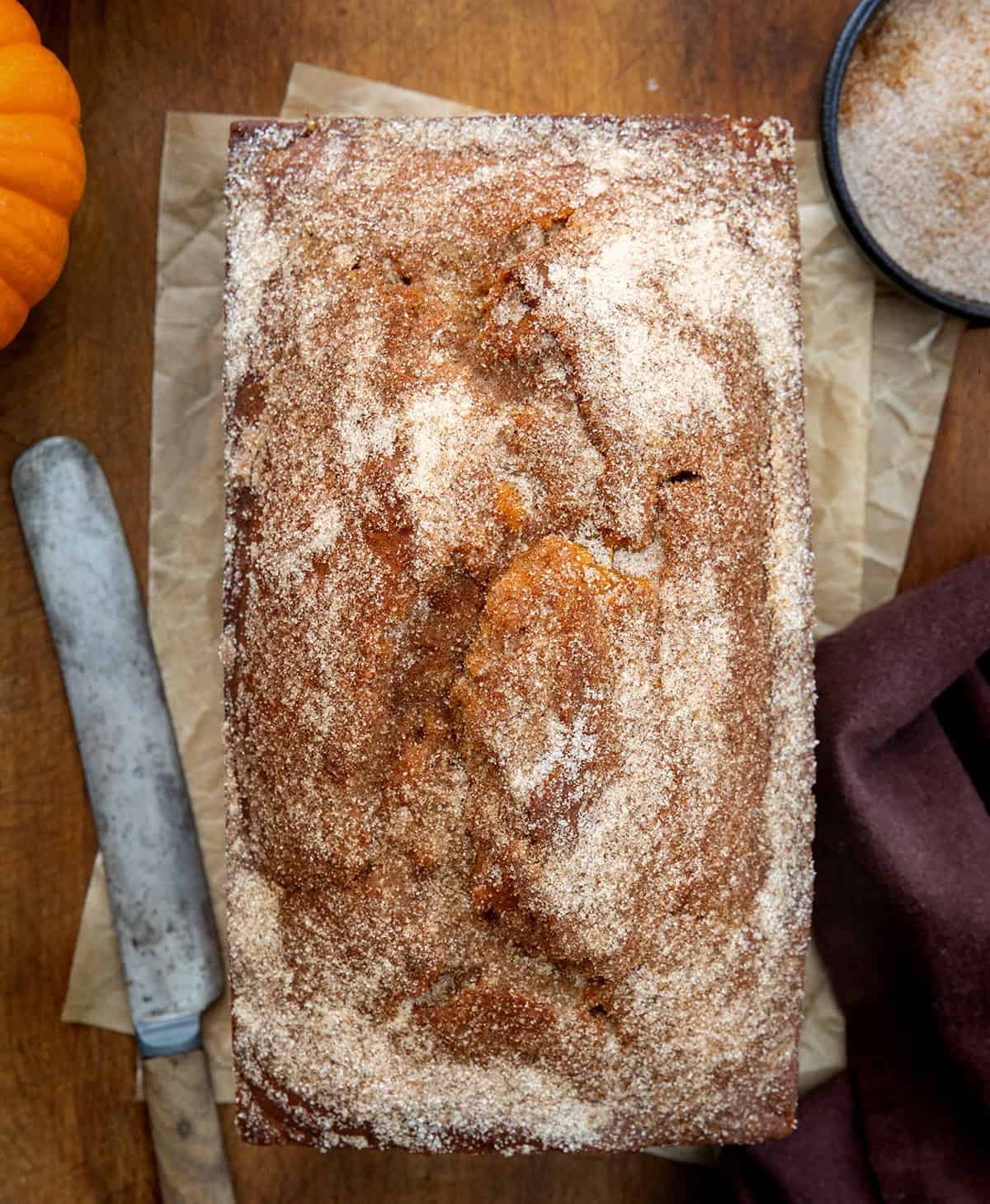 Pumpkin Donut Bread on a wooden table from overhead.